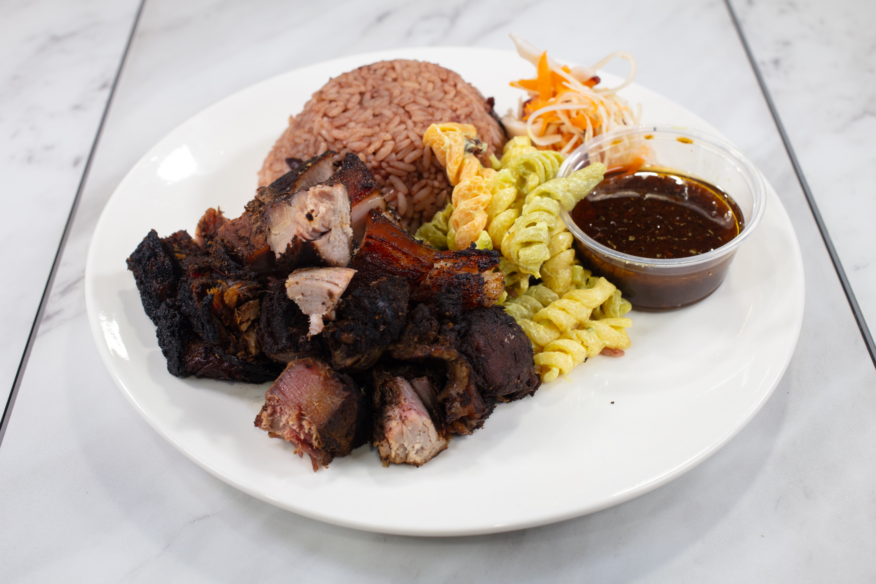 Jerk pork meal with rice and sides